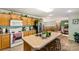A bright eat-in kitchen with a center island, stainless steel refrigerator, and updated appliances at 746 Joe Lentz Rd, Salisbury, NC 28146