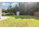 Spacious backyard with a storage shed surrounded by mature trees and lush green grass at 7643 Monarch Birch Ln, Charlotte, NC 28215