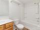 Clean bathroom with a wood vanity, toilet, and a bathtub with shower; designed for comfort and convenience at 7643 Monarch Birch Ln, Charlotte, NC 28215