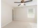 Comfortable bedroom features a neutral carpet, ceiling fan, and a window for natural light at 7643 Monarch Birch Ln, Charlotte, NC 28215