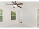 Serene bedroom with plush carpeting, a ceiling fan, and natural light streaming through the window at 7643 Monarch Birch Ln, Charlotte, NC 28215