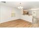 Inviting dining area with wood floors, a stylish chandelier, and a convenient view of the kitchen at 7643 Monarch Birch Ln, Charlotte, NC 28215