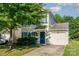 Charming two-story home with a well-manicured lawn, attached garage, and inviting blue door at 7643 Monarch Birch Ln, Charlotte, NC 28215