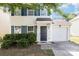 Charming two-story home featuring a single-car garage and a well-maintained front yard with lush greenery and dark blue shutters at 7643 Monarch Birch Ln, Charlotte, NC 28215
