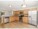 Well-equipped kitchen featuring stainless steel appliances, wood cabinets, and a stylish backsplash; perfect for cooking and dining at 7643 Monarch Birch Ln, Charlotte, NC 28215