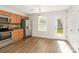 Functional kitchen with stainless steel appliances, wood cabinets, and an adjacent dining area with a door leading to the backyard at 7643 Monarch Birch Ln, Charlotte, NC 28215