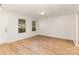 Bright living room featuring hardwood floors, neutral walls, and natural light streaming through two large windows at 7643 Monarch Birch Ln, Charlotte, NC 28215