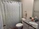 Well-lit bathroom featuring a granite vanity, white cabinets, and a shower with patterned curtain at 811 Constantine Rd, Richburg, SC 29729
