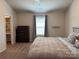 Bedroom with a large bed, dresser, window, and a view of the ensuite bathroom at 811 Constantine Rd, Richburg, SC 29729