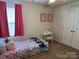 This bedroom has carpet, a small vanity, and a window covered by dark pink curtains at 811 Constantine Rd, Richburg, SC 29729