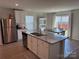 Kitchen featuring a granite island, stainless steel appliances, white cabinetry and a view into the dining area at 811 Constantine Rd, Richburg, SC 29729