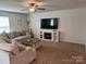 Spacious living room with a fireplace, television, sofa, and a ceiling fan at 811 Constantine Rd, Richburg, SC 29729