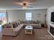 Spacious living room featuring a large sectional couch and a modern ceiling fan at 811 Constantine Rd, Richburg, SC 29729