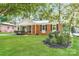 Charming brick home featuring a well-maintained lawn and mature trees at 835 Carrington Dr, Charlotte, NC 28214