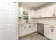 Updated kitchen features white cabinets, stainless appliances, and modern faucet at 835 Carrington Dr, Charlotte, NC 28214