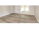 Bright living room with modern floors, a large window, and a neutral color palette at 835 Carrington Dr, Charlotte, NC 28214