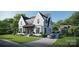 Gorgeous white brick home showcases lush landscaping, a private driveway, and a detached garage at 914 Edinburgh Ln, Charlotte, NC 28209