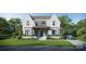Beautiful white brick home featuring black trimmed windows, manicured landscaping, and a modern design at 914 Edinburgh Ln, Charlotte, NC 28209