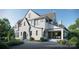 Expansive rear exterior of a white home featuring a covered porch perfect for outdoor dining and relaxation at 914 Edinburgh Ln, Charlotte, NC 28209