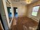 Bedroom featuring wood floors, bright window, and an open doorway to another room at 1004 S Ridge Ave, Kannapolis, NC 28083