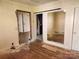 Bedroom with sliding barn door, hardwood floors, and doorway to a bathroom at 1004 S Ridge Ave, Kannapolis, NC 28083