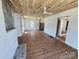 Spacious living room featuring wood-look floors, unfinished walls, and a ceiling fan at 1004 S Ridge Ave, Kannapolis, NC 28083