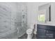 Modern bathroom featuring glass shower and marble tile at 10119 Laurier Ln, Huntersville, NC 28078