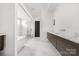 Sleek bathroom featuring marble countertops, modern cabinetry, and a glass-enclosed shower at 10119 Laurier Ln, Huntersville, NC 28078