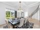 Formal dining room with a modern chandelier, a staircase, and hardwood floors at 10119 Laurier Ln, Huntersville, NC 28078