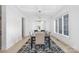 Formal dining room with a modern chandelier, large window, and hardwood floors at 10119 Laurier Ln, Huntersville, NC 28078