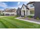 Stunning home exterior with dark brick, light accents, professionally landscaped yard, and an attached garage at 10119 Laurier Ln, Huntersville, NC 28078