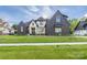 Beautiful home exterior with dark brick, light accents, professionally landscaped yard, and covered windows at 10119 Laurier Ln, Huntersville, NC 28078