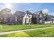 Beautiful home exterior with dark brick, light accents, professionally landscaped yard, and natural light at 10119 Laurier Ln, Huntersville, NC 28078