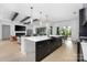 Modern kitchen featuring an oversized island with seating open to the living room at 10119 Laurier Ln, Huntersville, NC 28078