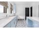 Spacious laundry room with island, blue cabinets and built in bench at 10119 Laurier Ln, Huntersville, NC 28078