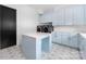 Well-appointed laundry room with blue cabinets, island and modern appliances at 10119 Laurier Ln, Huntersville, NC 28078