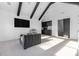 Bright room with dark beams, a wet bar, and a comfortable seating area with a large screen television at 10119 Laurier Ln, Huntersville, NC 28078