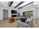 Bright and airy living room with beamed ceilings and a modern fireplace at 10119 Laurier Ln, Huntersville, NC 28078