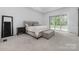 Serene main bedroom with neutral decor, plush carpet, and access to backyard at 10119 Laurier Ln, Huntersville, NC 28078