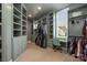 Spacious walk-in closet featuring custom shelving, storage drawers, and a built-in desk at 10119 Laurier Ln, Huntersville, NC 28078
