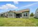 Well-manicured backyard with a lush green lawn and a screened porch for outdoor relaxation at 10120 Berkeley Castle Dr, Charlotte, NC 28273