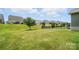 Spacious backyard featuring a well-kept lawn with a few trees and a view of the neighborhood at 10120 Berkeley Castle Dr, Charlotte, NC 28273