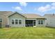 Well-maintained backyard featuring a lush green lawn and a screened porch for outdoor enjoyment at 10120 Berkeley Castle Dr, Charlotte, NC 28273