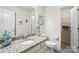 Bright bathroom featuring granite countertop vanity, white toilet, and walk-in closet for optimal storage at 10120 Berkeley Castle Dr, Charlotte, NC 28273