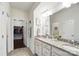 Elegant bathroom with double vanity, granite counters, and a view into a large walk-in closet at 10120 Berkeley Castle Dr, Charlotte, NC 28273