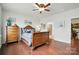 Comfortable bedroom with hardwood floors, a decorative bed, and ensuite bath access at 10120 Berkeley Castle Dr, Charlotte, NC 28273