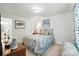 Charming bedroom with a floral patterned bed, wood nightstand, and stylish decor to complete the cozy space at 10120 Berkeley Castle Dr, Charlotte, NC 28273