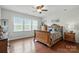 Inviting bedroom featuring hardwood floors, natural light, and a classic wooden bed frame at 10120 Berkeley Castle Dr, Charlotte, NC 28273