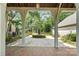 Picturesque courtyard view framed by a wooden arbor, features brick paving and manicured landscaping at 10120 Berkeley Castle Dr, Charlotte, NC 28273
