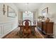 Formal dining room with hardwood floors, elegant wainscoting, and sophisticated chandelier at 10120 Berkeley Castle Dr, Charlotte, NC 28273